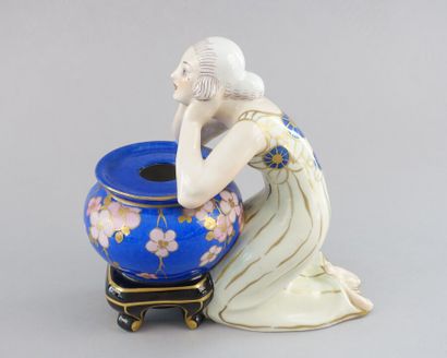 null Ceramic subject representing a woman kneeling and leaning on a blue vase.

Marked...