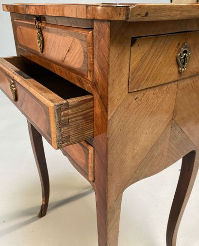 null Small writing table in rosewood and violet wood, opening with three drawers...