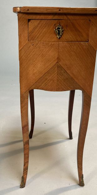 null Small writing table in rosewood and violet wood, opening with three drawers...