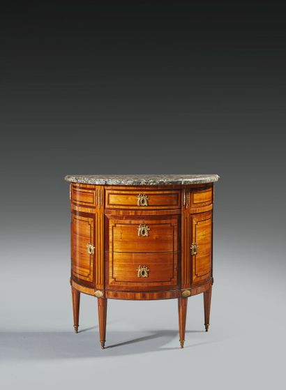 null A rosewood and amaranth half-moon chest of drawers, opening to three drawers...