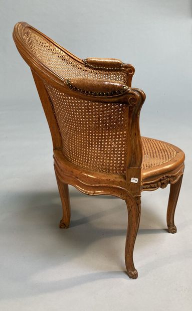 null Beechwood caned desk armchair, molded and carved, with foliage and flowers decoration,...