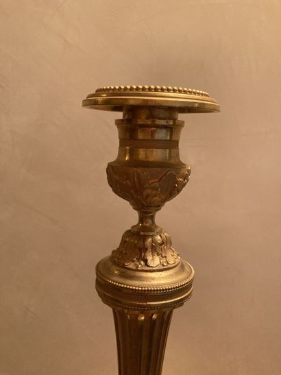 null Pair of ormolu torches, the fluted shaft, the circular base decorated with acanthus...