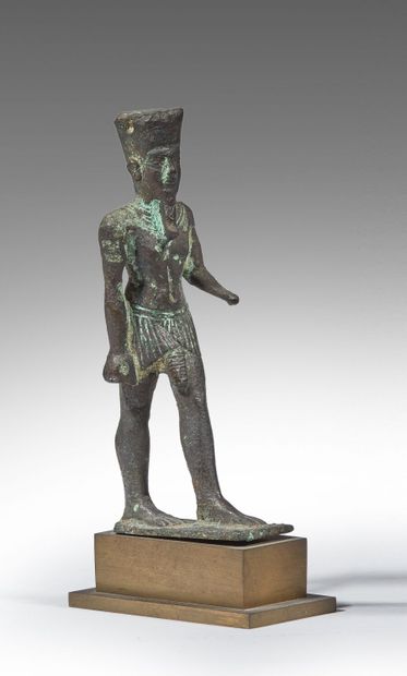 Figure of Amun walking, dressed in a short...