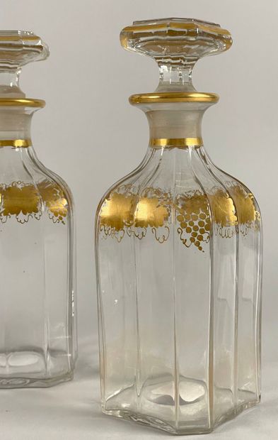 null Four faceted quadrangular covered carafes with gilded vine frieze decoration,...