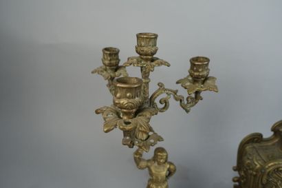 null Gilded metal mantel set including a clock and two candlesticks decorated with...