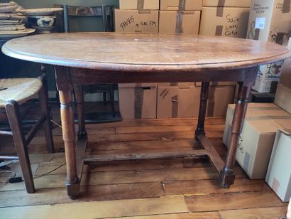 null Oval dining table with natural wood legs joined by a brace.
(Damage and missing...