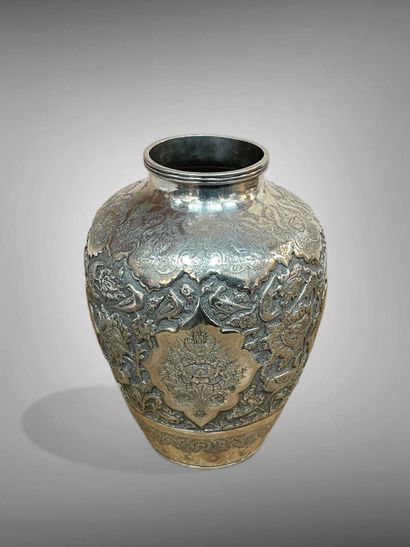 null IRAN 
A silver ovoid vase with a small annular neck, embossed and engraved with...