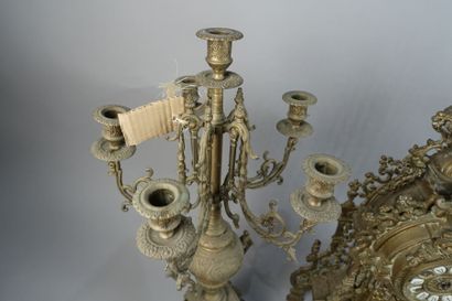 null Gilded metal mantel set including a clock and two candelabras decorated with...