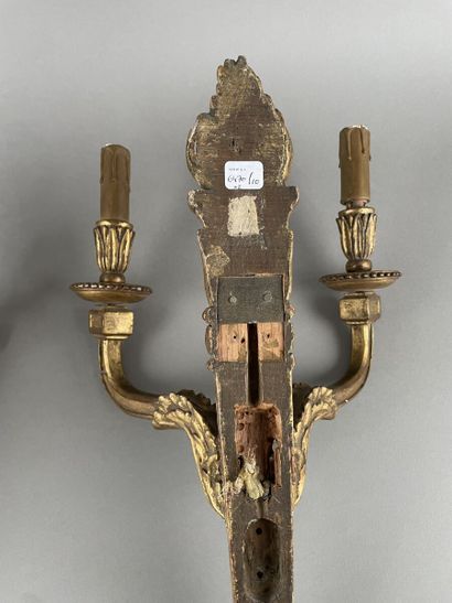 null Pair of carved and gilded wood sconces with two light arms, decorated with interlacing,...