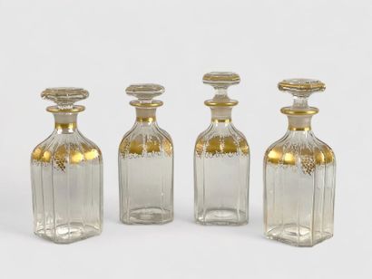 null Four faceted quadrangular covered carafes with gilded vine frieze decoration,...