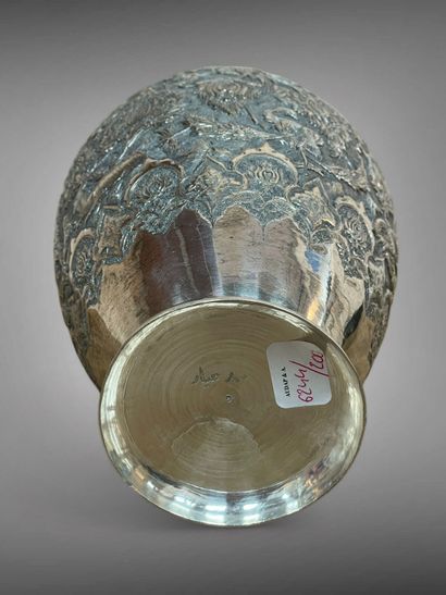 null IRAN 
An ovoid silver vase with a short circular neck, the decoration embossed...