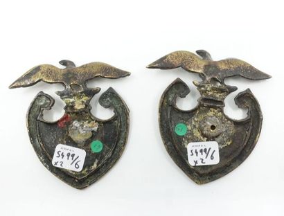 null Pair of bronze motifs with shield decoration in N surmounted by the Imperial...