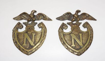 null Pair of bronze motifs with shield decoration in N surmounted by the Imperial...