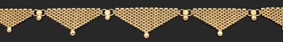 null Collier articulé en or jaune 750 millièmes composé de sept motifs triangulaires...