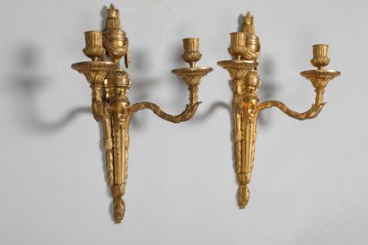 null 
A pair of chased and gilt bronze sconces with two arms of light decorated with...