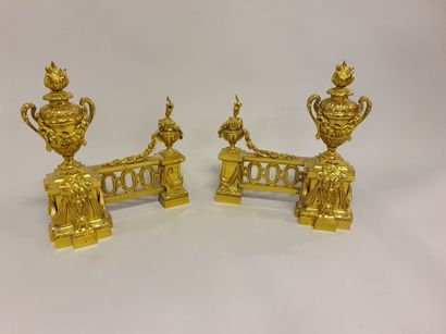null 
Pair of chased and gilt bronze andirons decorated with fire pots and hanging...