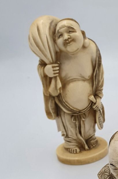 null 
Ivory OKIMONO representing a character holding his bundle on the shoulder
China,...