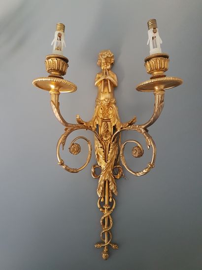 null 
A set of 4 sconces in chased and gilt bronze with two arms of lights decorated...