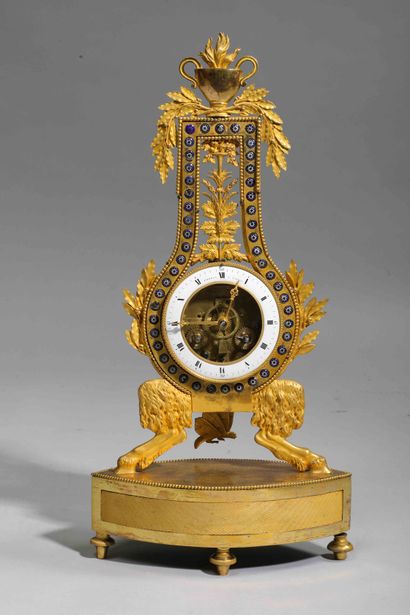 null 
Lyre clock in gilt bronze and enamelled decoration surmounted by a cassolette...