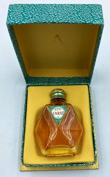 4711 4711 " Carat " 

Glass bottle, sculptural shape, triangular label, titled. Golden...
