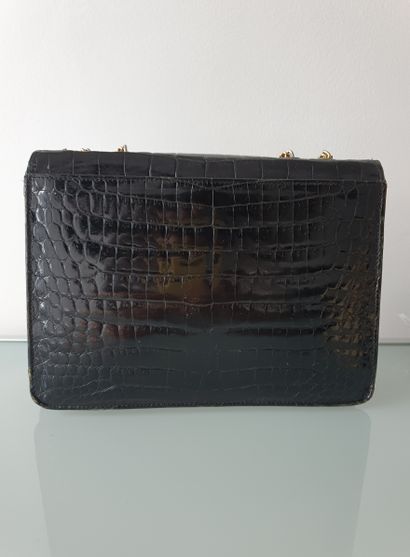 null Set of two bags:



- One hand or shoulder bag in black crocodile, gold metal...