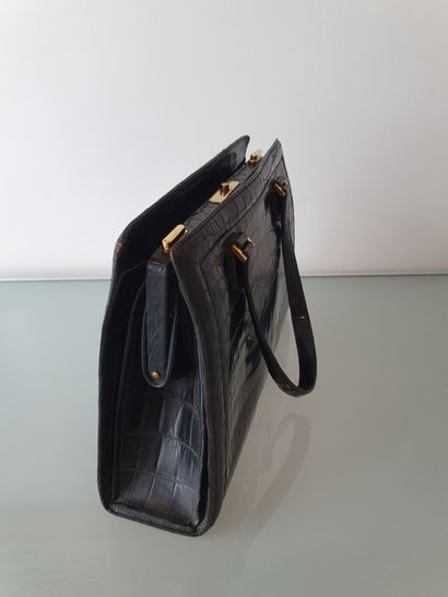 null 
HERMES Paris

Black pre-convention crocodile bag with gussets and two handles,...