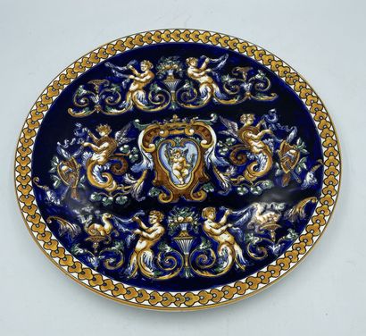 GIENS GIENS

Earthenware dish with polychrome decoration of grotesques on a blue...
