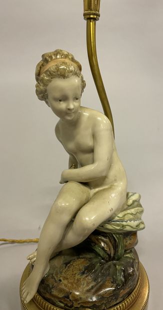 PIED DE LAMPE 
LAMP STAND in glazed ceramic representing Eve holding a snake, gilded...