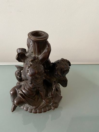 BRONZE Chased bronze torch holder with brown patina decorated with three putti

Height...