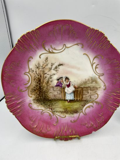 DEUX ASSIETTES TWO polychrome porcelain plates with a partly serrated edge, decorated...