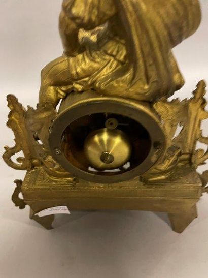 PENDULE Gilded metal HANGER decorated with a young girl hunter holding a bird resting...