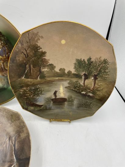 ASSIETTES TWO hollow porcelain plates decorated with a lake landscape in the center...