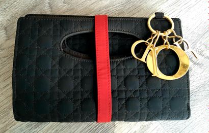 Christian DIOR Christian DIOR

Black quilted fabric pouch, red bow and gold metal...