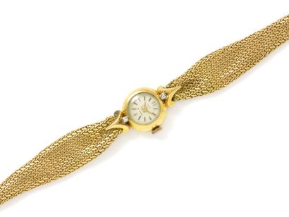 Montre bracelet de dame en or 750 millièmes, cadran ivoire taché avec index bâtons...