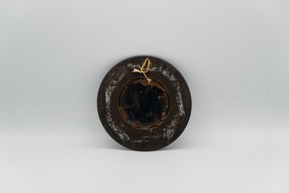 null 
Small medallion in polychrome painted enamel with gold highlights representing...