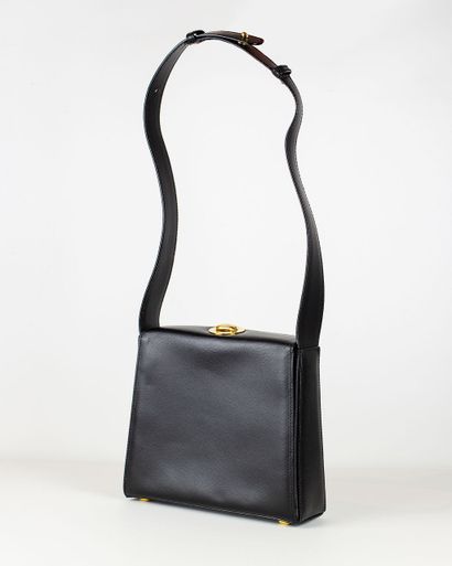 null 
CELINE


Black grained leather bag, opening at the top with a circular golden...