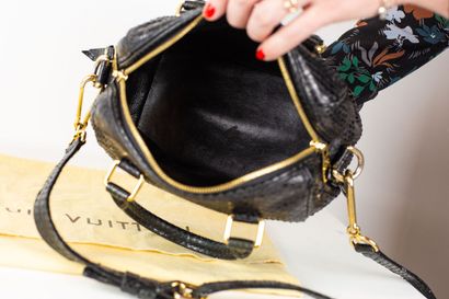 null 
LOUIS VUITTON


Bag model 
Speedy in black python and gold metal trim, with...
