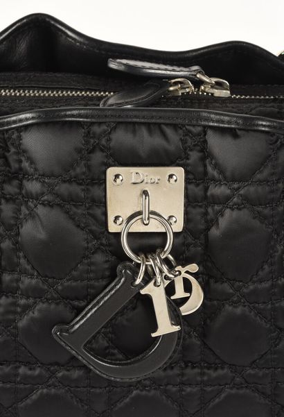 CHRISTIAN DIOR Black nylon bag with cane pattern and silver metal. The handles wrapped...