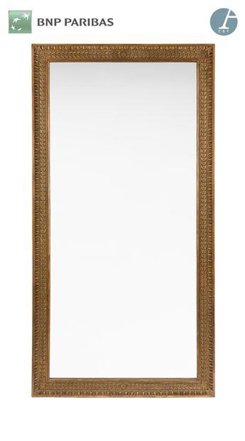 null Mirror, the frame in molded wood, carved and gilded decorated with a frieze...