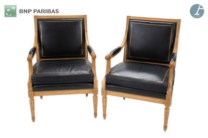 null Pair of armchairs. Seat and back in black leather with gold trim. Molded and...