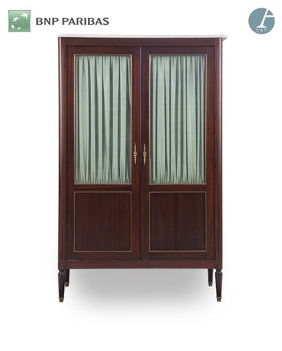 null Bookcase in natural wood and mahogany veneer, opening by two glass doors with...