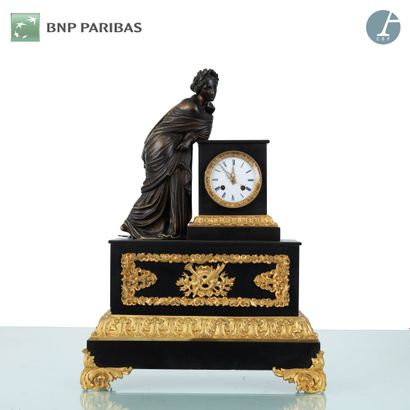 null A patinated bronze, gilt bronze and black marble clock with stylized foliage...