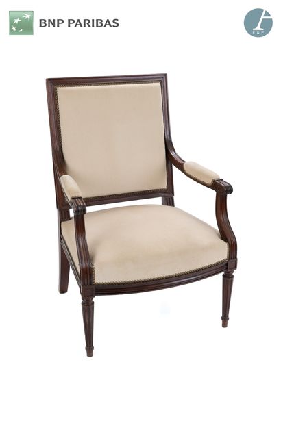 null A large molded and carved natural wood armchair, beige velvet upholstery,
Louis...