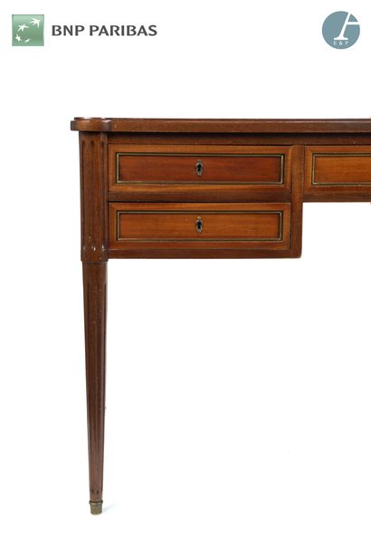 null Mahogany flat desk opening to five drawers and two sliding shelves, resting...