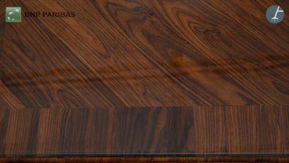 null Rectangular table in rosewood, opening to a lateral drawer, resting on cambered...