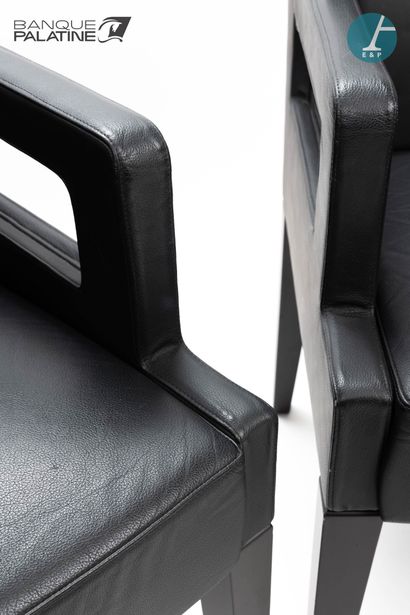 null Pair of wooden armchairs covered with black leather, wooden tapered legs.

H...