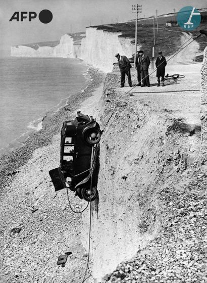 null AFP

Men watching a vehicle fall from a cliff on the Normandy coast, 1930s....