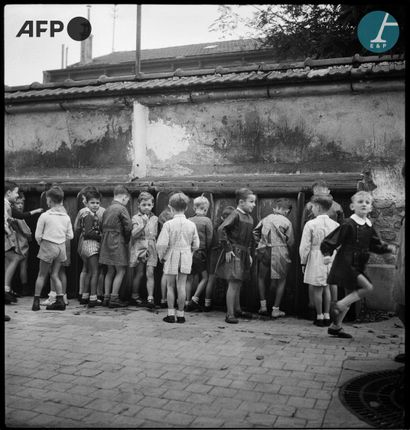 null 
AFP



Schoolchildren taking a bathroom break in the courtyard of an elementary...