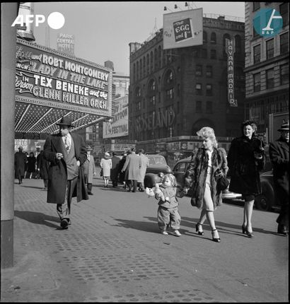 null 
AFP - Eric SCHWAB




A woman and child cross 51st Street near the Roseland...