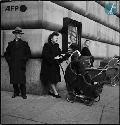 null 
AFP - Eric SCHWAB




Old man looking at a child standing in his wicker stroller...